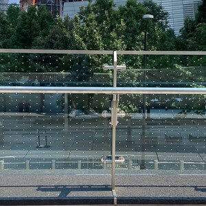 Bird-safe glass installed along the glass railway at World Trade Center's Liberty Park. This bird-safe measure was implemented in part due to pressure from NYC Audubon volunteers who were finding many dead birds that had collided with the reflective glass. Photo: NYC Audubon