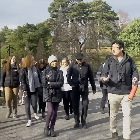 New guide Woo Sung Park leads participants on a bird tour in the New York Botanical Garden. Photo: Tank Brain Productions