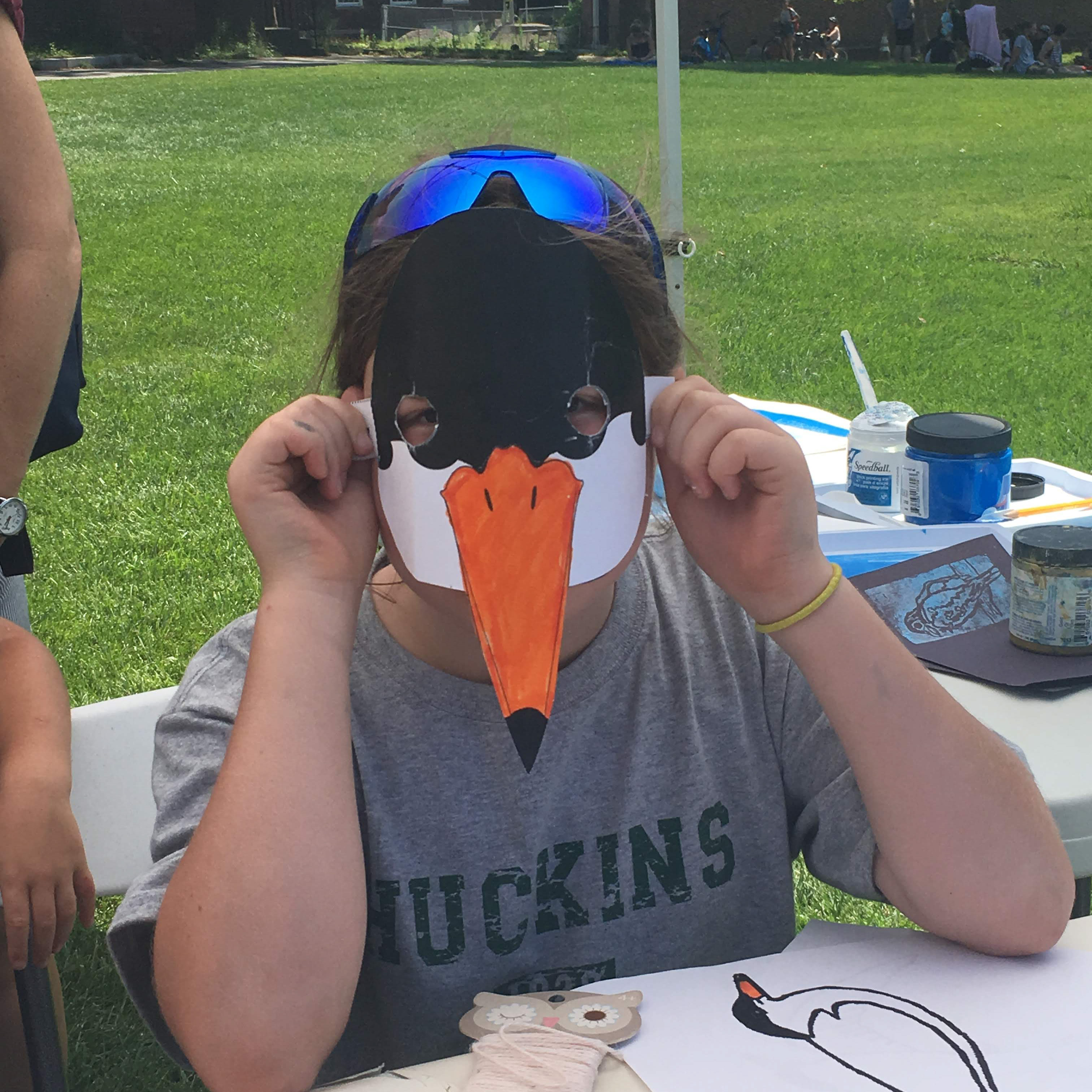 A visitor to Governors Island shows off a Common Tern mask. Photo: NYC Audubon