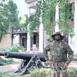 Artist Dennis Redmoon Darkeem dressed in military garb stands in front of cannons on Governors Island. Photo: Dennis Redmoon Darkeem